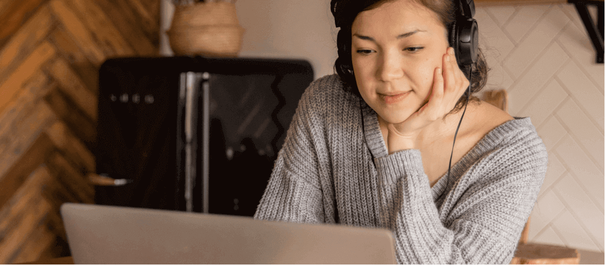 24 Must-Listen Podcasts for Photographers in 2025 A woman listening to a podcast