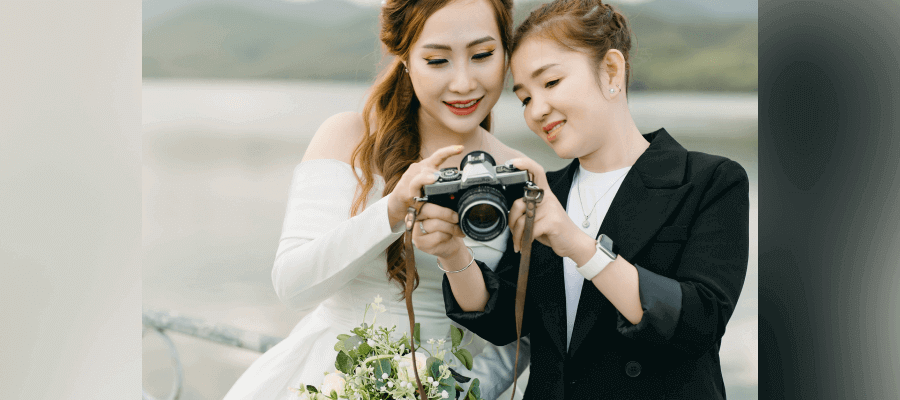 5 Steps to Perfecting Your Wedding Photo Editing A photographer showing images to a client on her camera