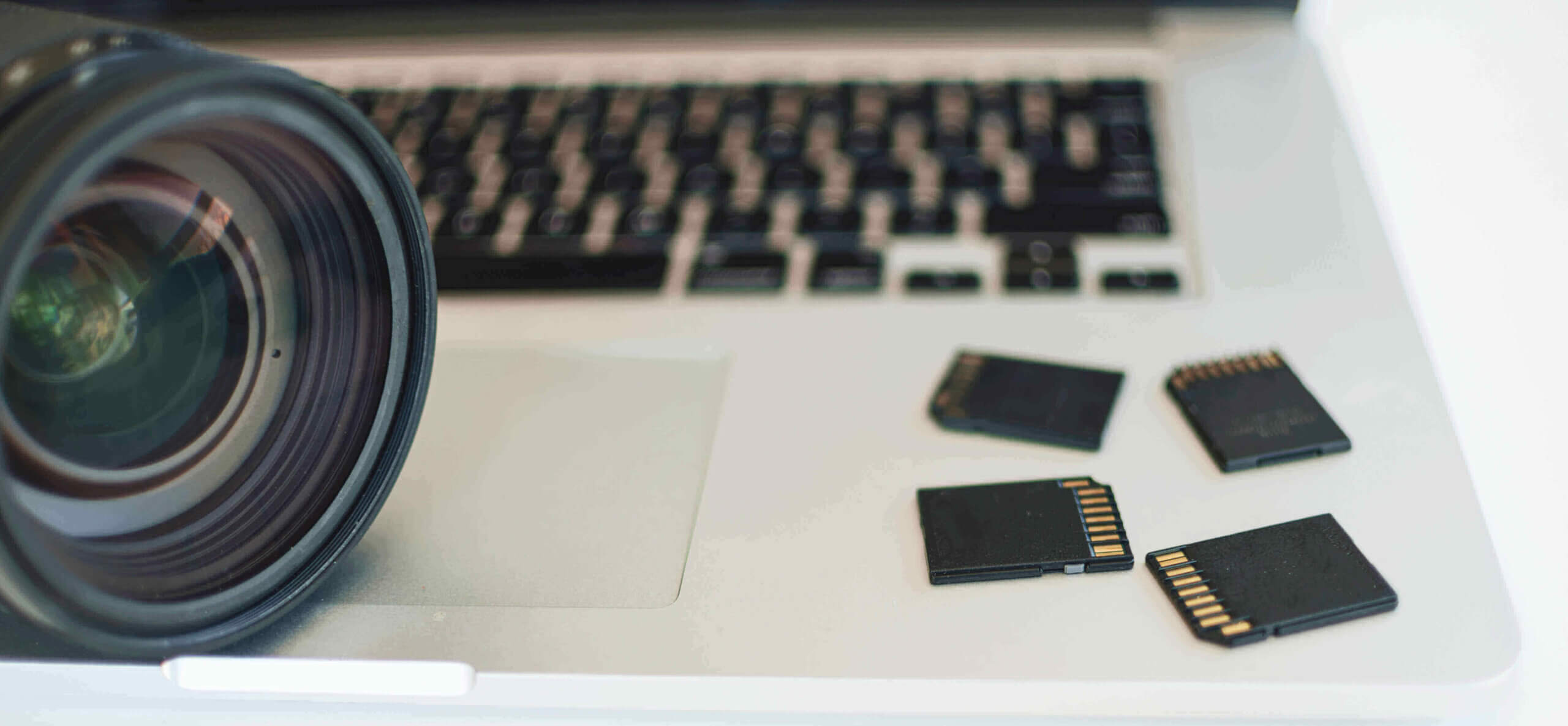 10 Best External Hard Drive for Photographers with 4TB+ Storage Space Image by Freepik with photography memory cards and a camera on a laptop