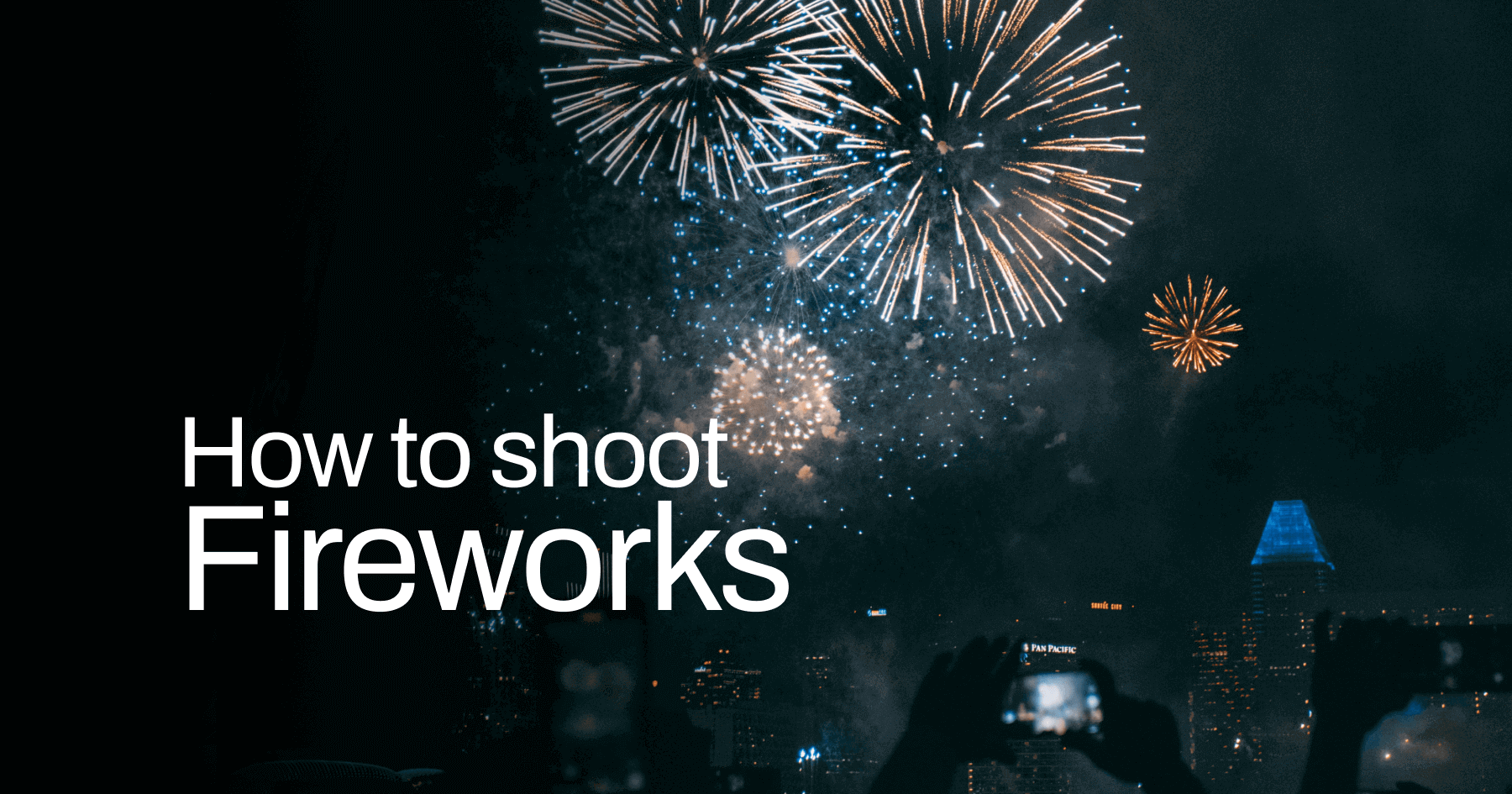 How to Photograph Fireworks: A Guide for the Professionals Picture of fireworks with people holding up their cameras in the foreground.
Text on top of the picture: How to shoot fireworks