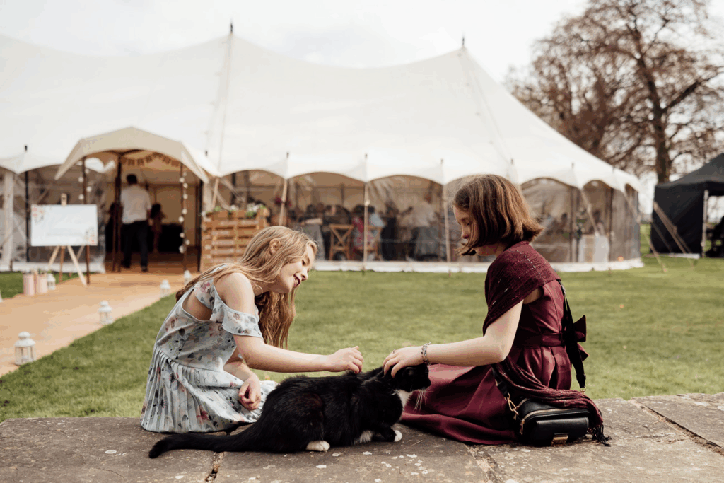 Capturing candid photos of children playing with a cat