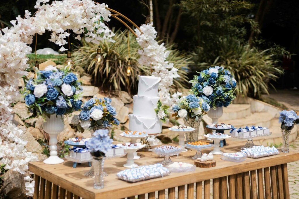 luxury wedding photography of the decorated table with cakes and carnations