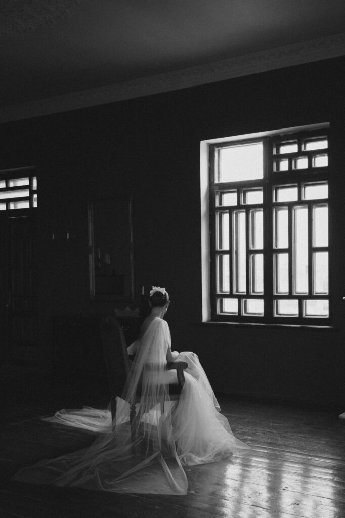 bride sitting near window